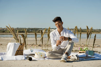 A man on the beach wearing men’s vacation clothes